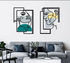 a living room with two paintings on the wall