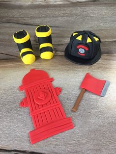 a pair of yellow and black shoes sitting on top of a wooden table next to a red fire hydrant