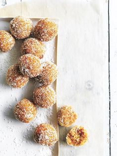 some sugared doughnuts are on a plate