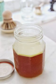 a jar filled with liquid sitting on top of a counter