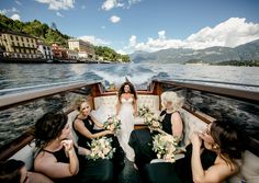 the bride and her bridesmaids are sitting on a boat with their bouquets