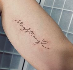 a woman's arm with a tattoo that says, love and hearts on it