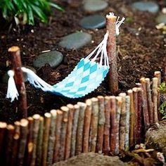 a miniature hammock is sitting in the dirt