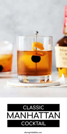 the classic manhattan cocktail is served in a glass with an orange peel