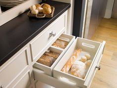 an open drawer in a kitchen filled with pastries