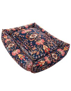 a blue and red floral print dog bed with an intricate design on the bottom side