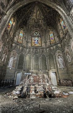 an old church with stained glass windows and graffiti on the walls that reads urban exploration