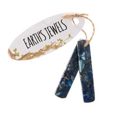 two pieces of blue and white marble are hanging from twine with the words earth's jewels on it