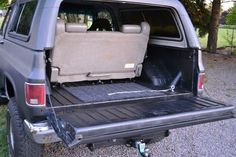 the back end of a pickup truck with its cargo compartment open