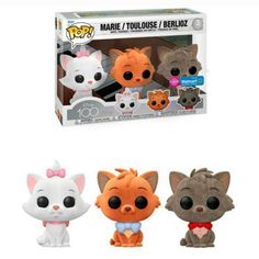 three pop vinyl toys are in front of a white box and one has an orange cat