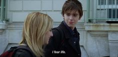 a young man and woman standing next to each other with the words i fear life written on them