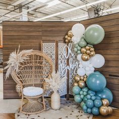 balloons and decorations are arranged on the floor in front of a wooden paneled wall