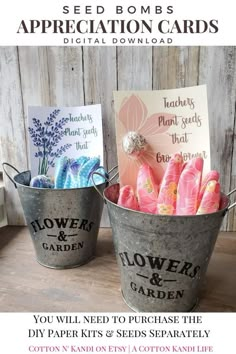 two buckets filled with flowers and seed cards