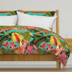 a bed with colorful floral comforter and pillows