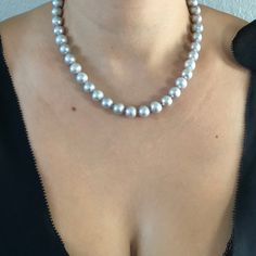 Freshwater Silver-Grey Bridal Pearl Necklace. This beautiful necklace is the epitome of class. One stand of gorgeous silvery grey pearls, hand strung and individually knotted. Quality pearl necklaces are always knotted between the pearls. This protects the pearls from rubbing together and becoming damaged. All pearls are natural and genuine. PEARL SIZE: 9.5-10.5 PEARL SHAPE: Round PEARL COLOR: Silvery Grey NECKLACE LENGTH: 18 inch CLASP: Sterling Silver Toggle Clasp Shipping is free on all domes Elegant Round Gray Jewelry, Elegant Gray Round Jewelry, Formal Gray Tahitian Pearl Jewelry, Classic Single Strand Silver Pearl Necklace, Elegant Gray Necklace Perfect For Gifts, Elegant Gray Necklace For Gift, Silver Single Strand Tahitian Pearl Necklace, Gray Pearl Necklace For Gifts, Gray Pearl Necklace For Gift