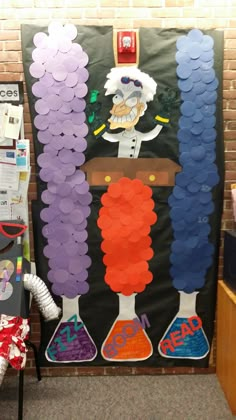 a classroom door decorated with purple and orange decorations