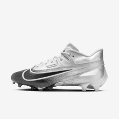 a white and black soccer shoe with silver accents on the upper part of the shoe