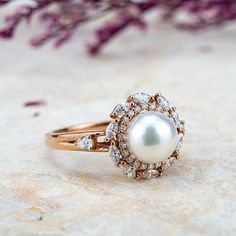 Embrace elegance with the Pearl Blossom Ring, featuring a lustrous Akoya pearl cradled in 14K solid gold. Handcrafted petals of precision-cut moissanite encircle the natural gem, reflecting a commitment to original, high-end design. 🌟 ITEM DESCRIPTION 🌟Handmade with meticulous craftsmanship.Metal Options: Solid 14K, and 18K Gold.Gold Colors Available: Rose gold, Yellow gold, White gold.💍 ENGAGEMENT RING 💍Center Stone: Akoya PearlSize: ≈7.4mmRound-ShapedAccent Stones:MoissaniteCut: Marquise&RoundColor Options: G-H / DEFClarity: VS-SI / VVS-VS✦ Width of the gold band -1.6 mm Custom Gold Rings, Rings Anniversary, Pearl And Diamond Ring, Full Eternity Ring, White Gold Engagement Ring, All Gems, Solid Gold Jewelry, Akoya Pearls, White Gold Engagement Rings