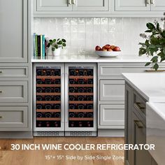 an image of a wine cooler in the middle of a kitchen with white cabinets and wood flooring