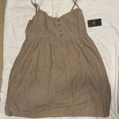 Brand: Volcom Size: S Above The Knee Length Dress 4 Buttons In Front With Adjustable Straps Color: Brown W/Stripes Summer V-neck Sleeveless Brown Dress, Brown V-neck Mini Dress For Summer, Sleeveless Brown Beach Cover-up Dress, Brown V-neck Beach Dress, Brown Cotton V-neck Mini Dress, Above The Knee, Knee Length Dress, Knee Length, Colorful Dresses