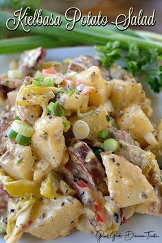 a white plate topped with pasta covered in sauce and veggies next to celery