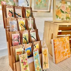 some cards are on display in front of other card holders and boxes with flowers painted on them