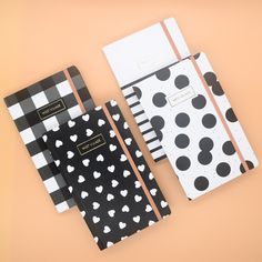 three notebooks with black and white polka dots on them