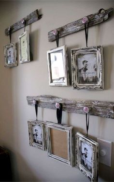 several frames are hung on the wall with hooks