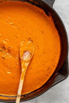 a wooden spoon in a pot filled with soup