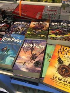 many harry potter books are stacked on top of each other in front of a display case