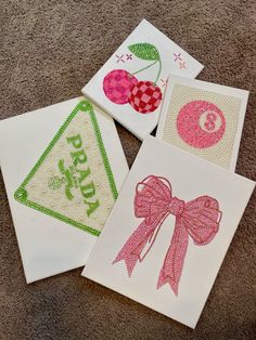 four handmade cards with designs on them sitting on the floor next to each other