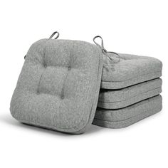 four grey cushions stacked on top of each other