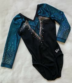 a leotard shirt with stars on it laying on a white sheeted surface