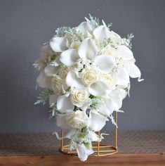 a bouquet of white flowers sitting on top of a table