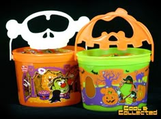 two halloween buckets with decorations on them