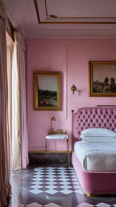 a bedroom with pink walls and white bedding in the center, along with two paintings on the wall