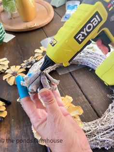 Use hot glue to attach the pinecones to the wreath Pinecone Crafts