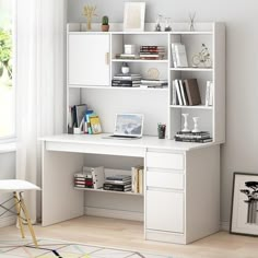 a white desk with books and pictures on the shelves next to a chair in front of a window