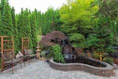 an outdoor patio with seating and water feature