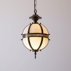 an old fashioned light hanging from a chain