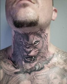 a man with tattoos on his neck and chest has a wolf tattoo on it's back