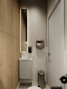 a bathroom with a toilet, sink and trash can in it's center wall