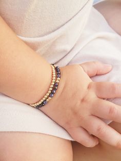 "Stacking Baby Bracelets are the perfect Toddler Bracelet Set Bracelet is adjustable to assure that exact measurement of wrist is not necessary. Because bracelet is adjustable, it grows with baby and will be a piece that the child can wear for years.  Slide ring makes taking bracelet on and off a breeze! Wiggly baby hands are no match for this bracelet. Option of specific and personalized birthstone. Adorable Two-in-One bracelet set. Set is made out of two bracelets. One bracelet being comprised Adjustable Stackable Bracelets For Birthday, Adjustable Round Beaded Bracelets With Birthstones, Adjustable Beaded Bracelets With Birthstone, Adjustable Beaded Bracelet With Birthstone, Adjustable Round Beaded Bracelet With Birthstone, Adjustable Gold Gemstone Bracelet Gift, Adjustable Gemstone Gold Bracelet For Gifts, Adjustable Gemstone Gold Bracelet As A Gift, Adjustable Bangle Bracelets With Birthstone