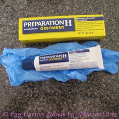 a tube of preparation h ointment next to a blue bag on the ground