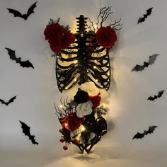 the skeleton is decorated with red roses and black branches for halloween decoration, as well as other decorations