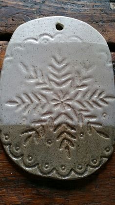 a white ceramic plate sitting on top of a wooden table next to a bottle opener