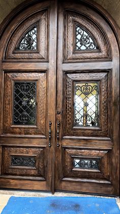 an ornate wooden door with glass inserts