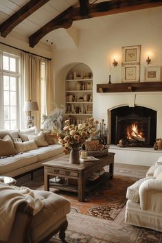 a living room filled with furniture and a fire place in the middle of a room