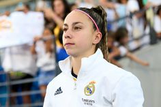 a female soccer player is looking at the crowd