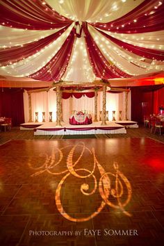 the dance floor is decorated with red and white drapes